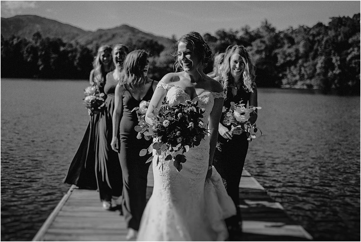bridesmaids posing on lake dock