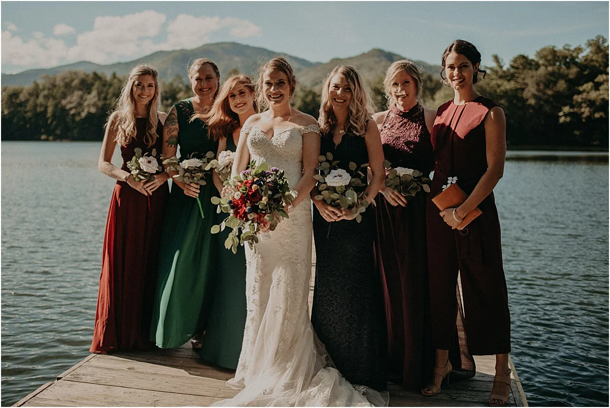 bridesmaids posing on lake dock