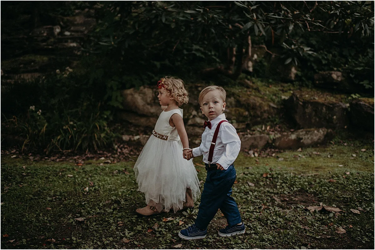 flower girl and ring bearer walking down aisle at wedding