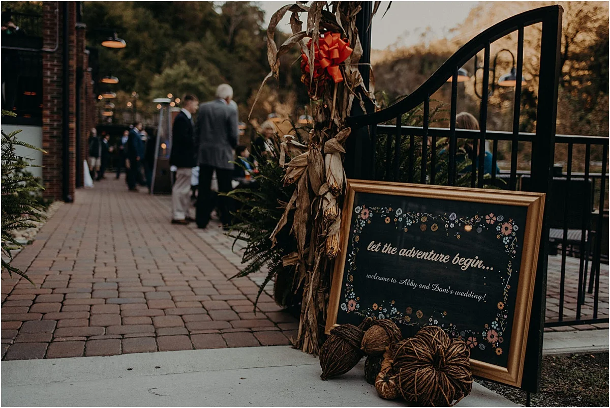 let the adventure begin wedding sign at reception