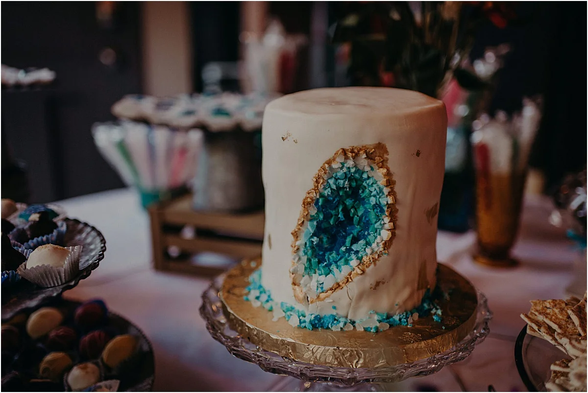 white wedding cake with blue stones