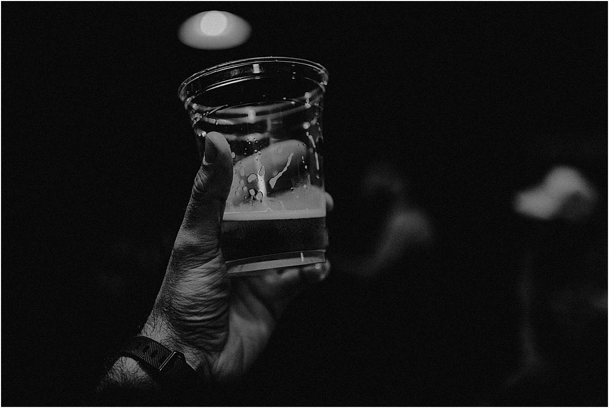 wedding guest holding up beer