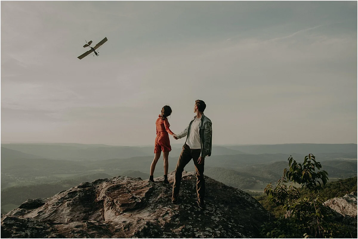 plane flying over couple on tennessee hills