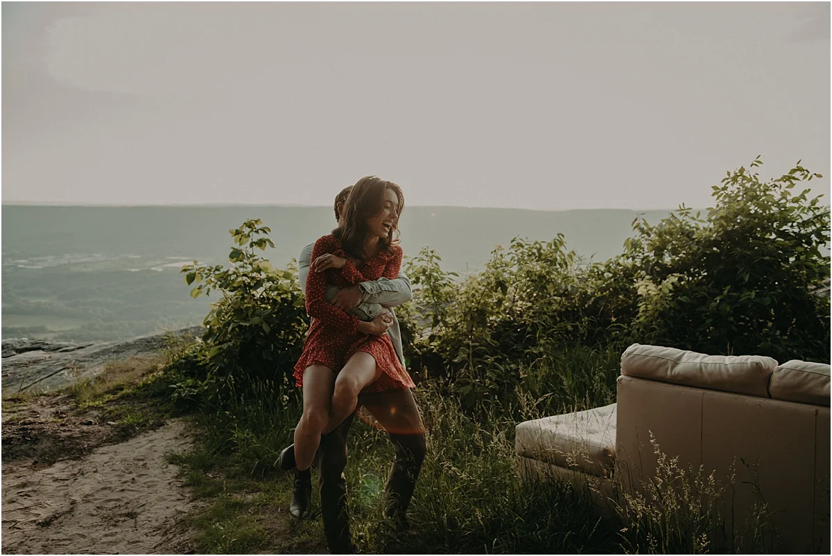 man holding his fiance in nature