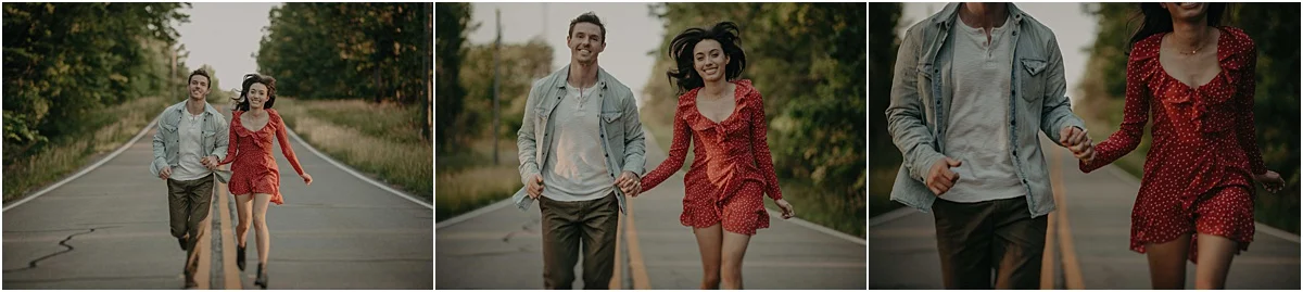 engaged couple running down the road while holding hands