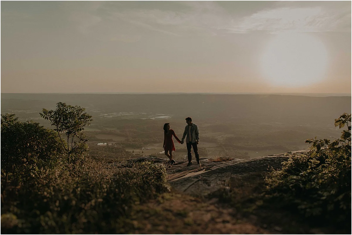 engaged couple holding hands over tennessee hills