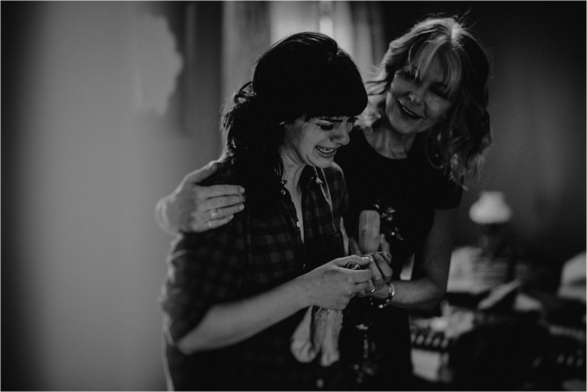 The mother of the groom comforts the bride as she breaks down into happy tears
