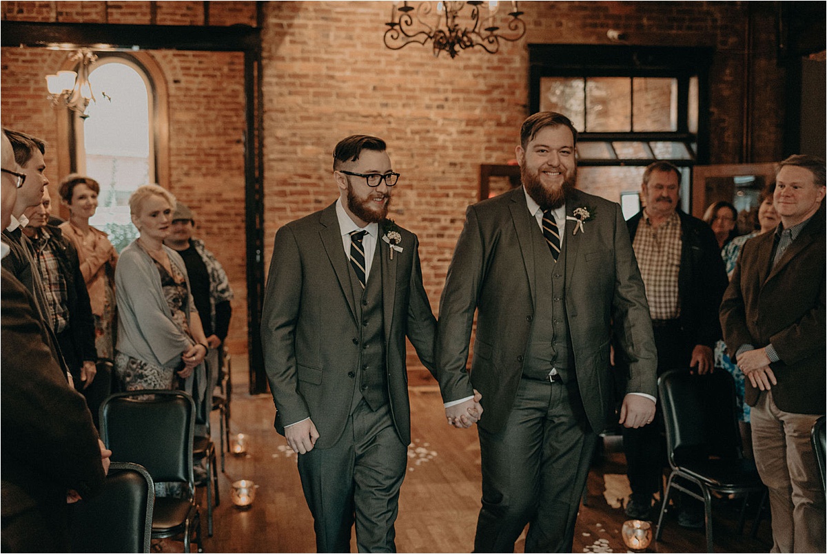 The grooms walk down the aisle together at this Chattanooga, Tennessee same sex wedding