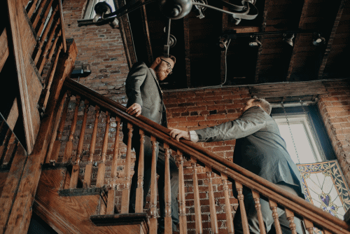A Gif image of the groom walking down the stairs to meet his groom.