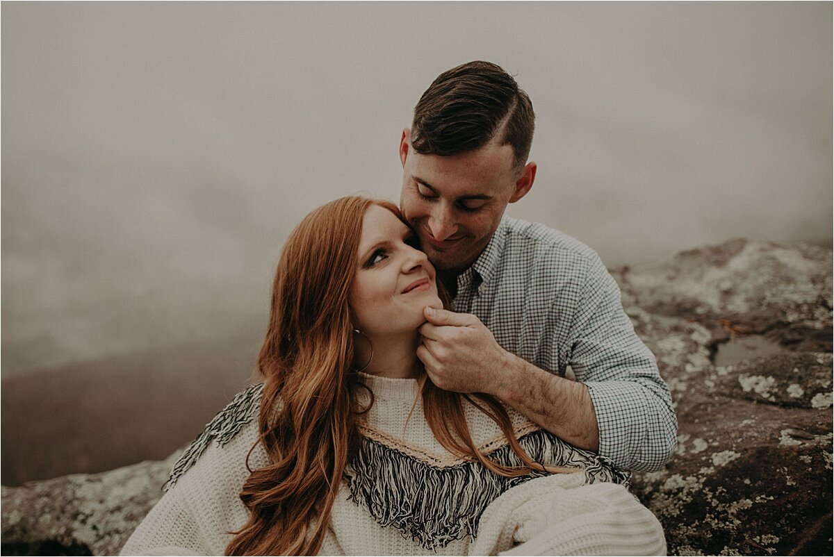 A sweet embrace by this newly engaged couple during their foggy love story photo session
