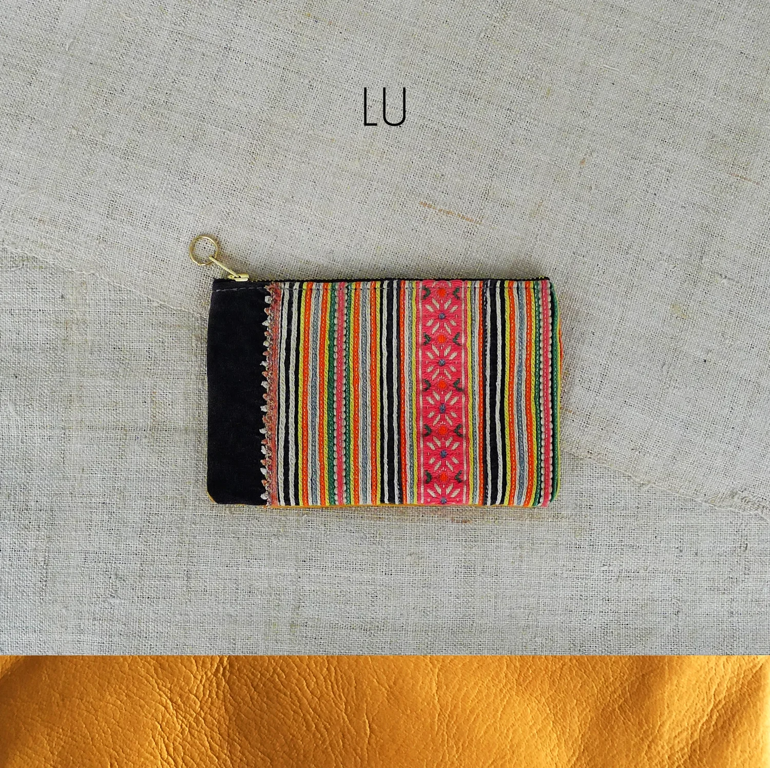 tribal textile + leather / zip fastening / inside pocket / name inspired by / The Kunlun mountain range are the longest chains across Asia, stretching out to over 3000km. / approx size / 10cm x 16cm (4" x 6.25") / suitable for / purse / coin + notes holder / cash card holder / travel card holder / earphones storage / general storage