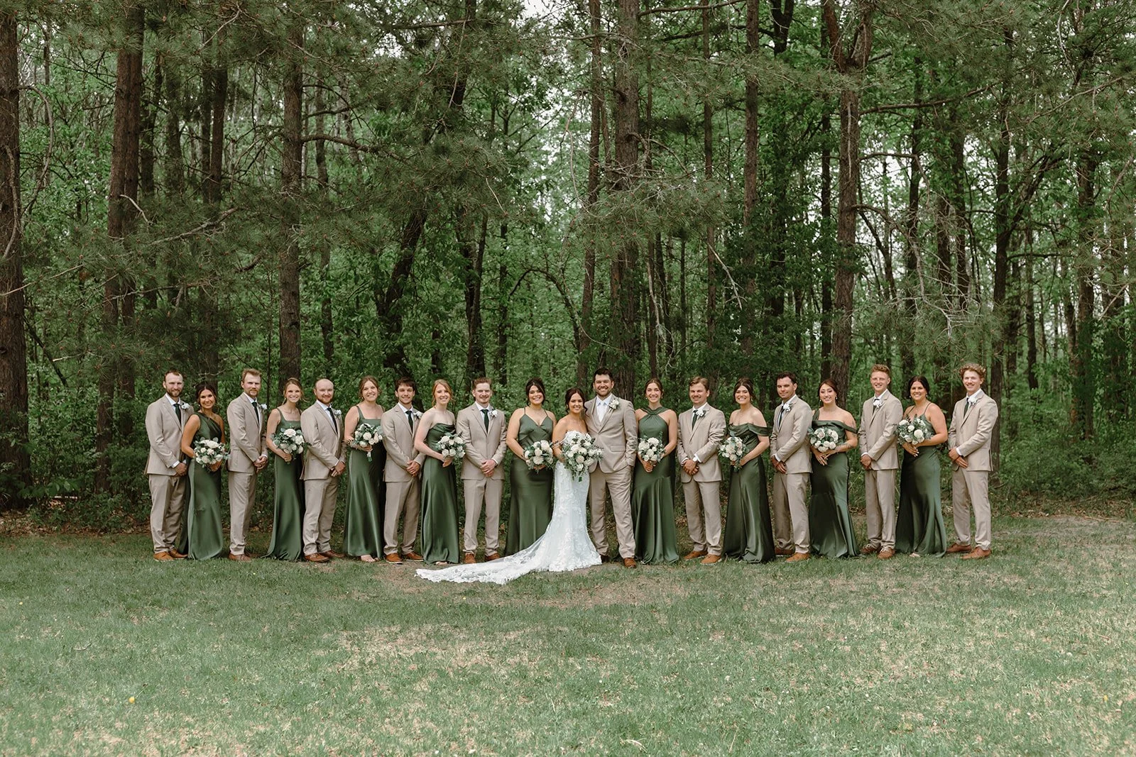 large wedding party in the pines