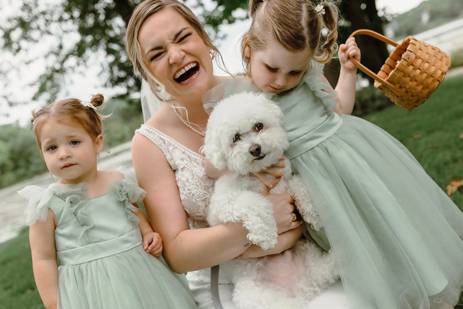bride with dog and flower girls laughing