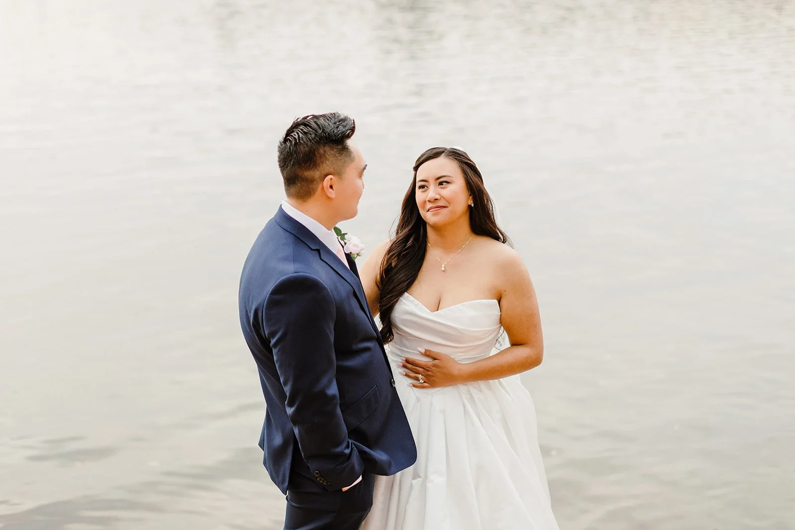 bride and groom hugging by the lake in nisswa, mn