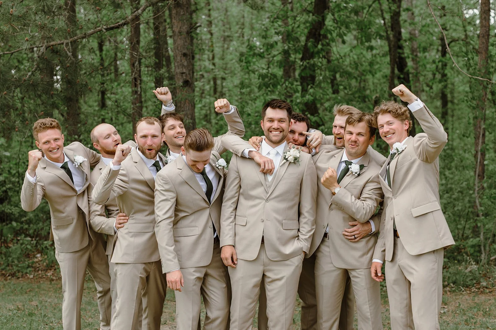 candid groomsmen in the pines