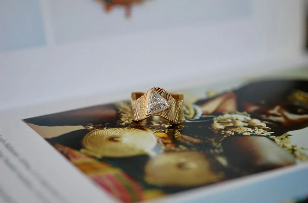 Sankofa. Past speaking to future.

Gold transforms to woven cloth. The secret language of textiles meets the distinctly modern geometry of a trillion-cut diamond.
&bull;
&bull;
&bull;
#charltonandlola #finejeweler #finejewelrydesign #heirloom
