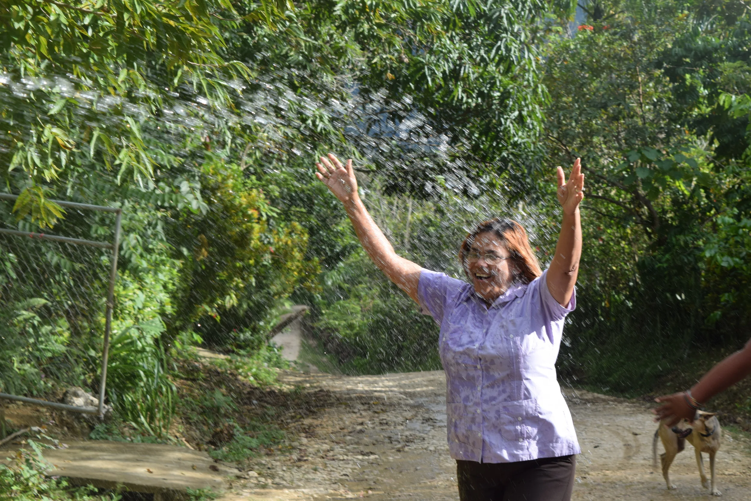 Senora Estrella, Vice-President of the Water Committee, celebrates as water arrives to the town.
