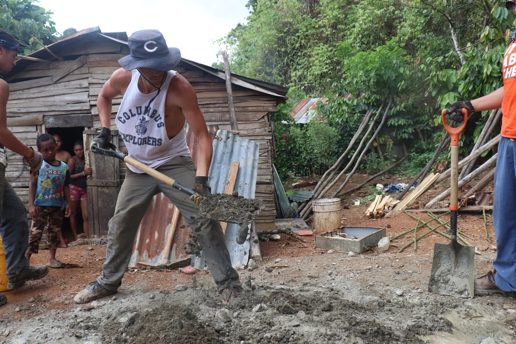 Volunteer digging a hole for an improved pit latrine.jpg