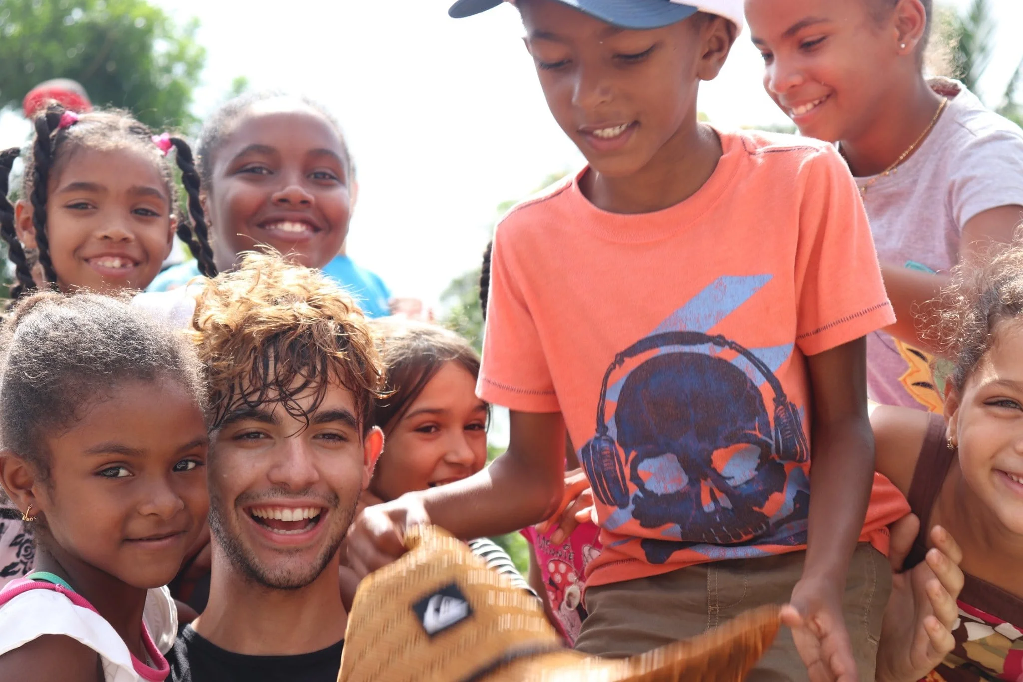 International Volunteer sorrounded by community kids.jpg