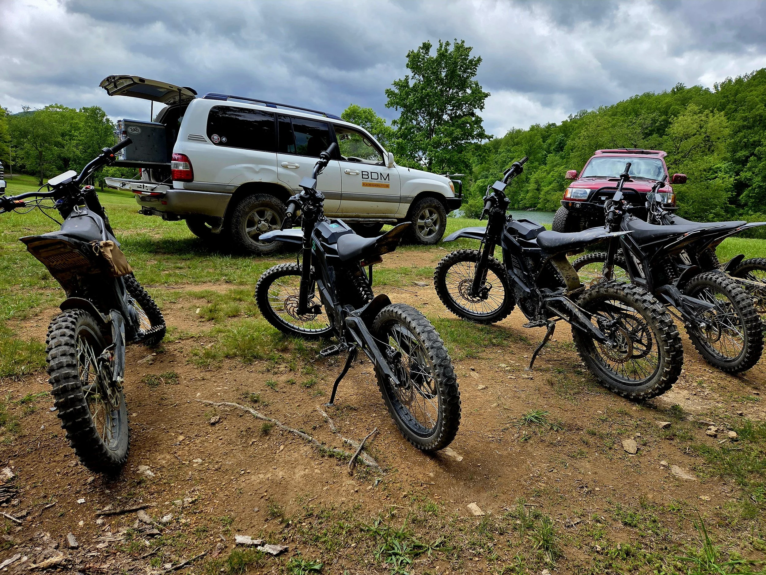 Black Dog Mobility electric off-road motorcycles and support vehicle