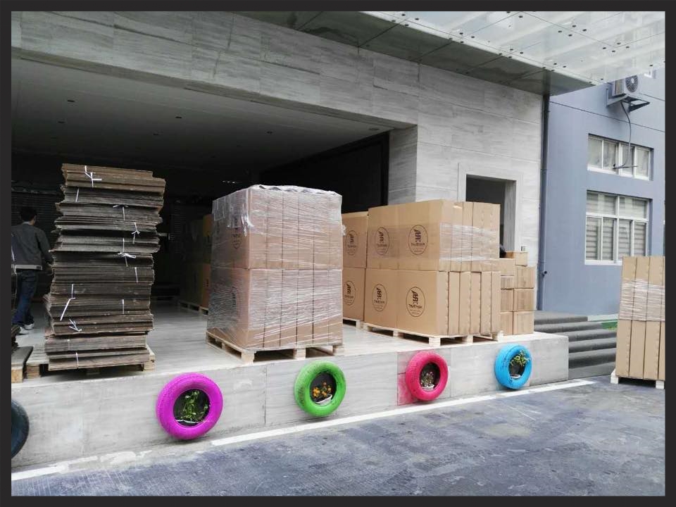 Loaded pallets of TruStack Tire Dollies waiting to be lifted into the container.