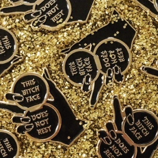 #001 BLACK + GOLD BITCH FACE PIN $12 Retail | $6 Wholesale | 1.5" Tall