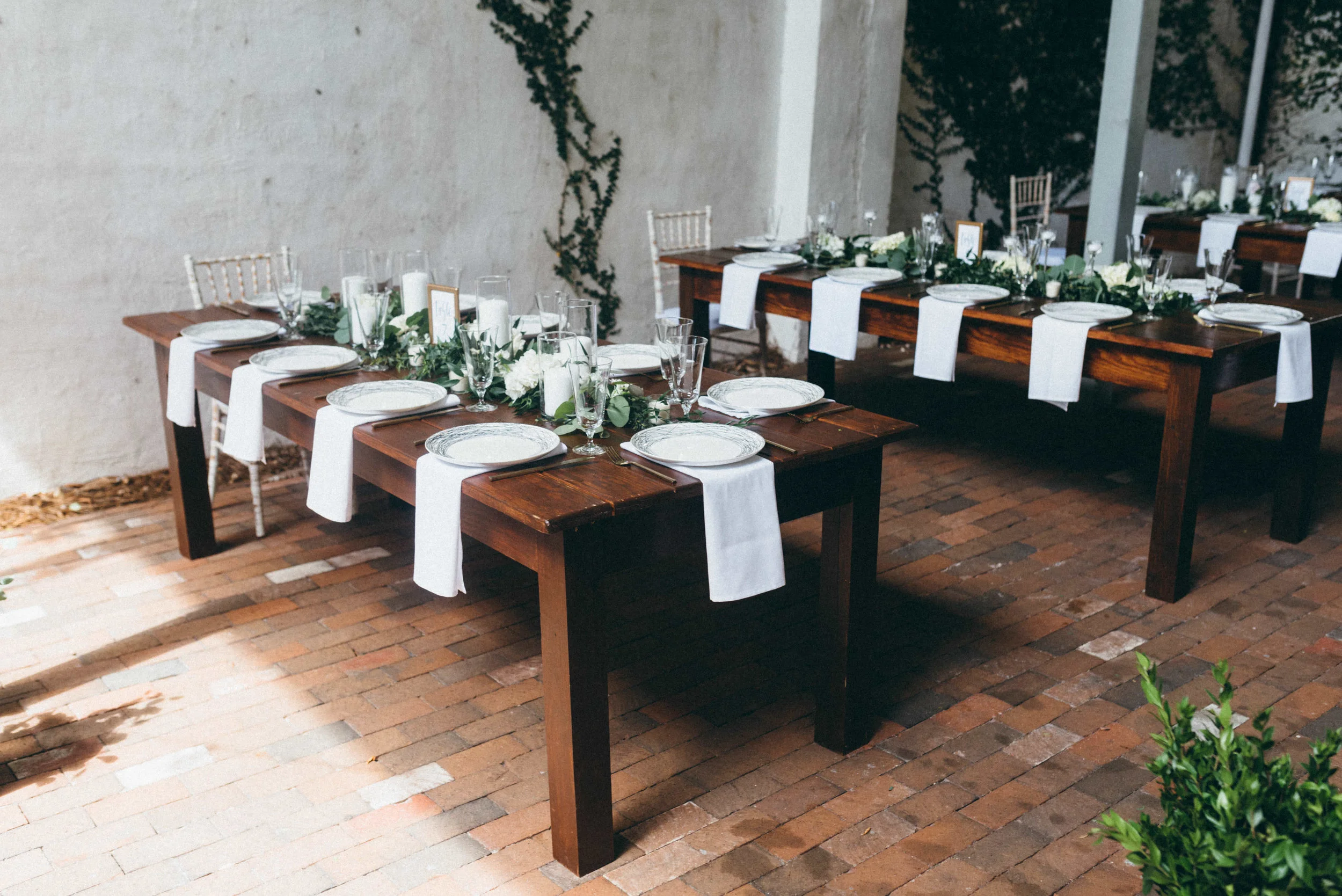 Setting up our Sir David Farm tables with a few Distressed Chiavari Chairs
