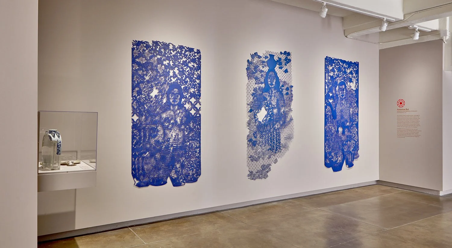  The Protectors stand proudly and alert, submerged in a field of vessels, instruments, motifs, patterns, and symbols sourced from the permanent collection. Even though many of the containers depicted are broken, or on the verge of crumbling, The Prot