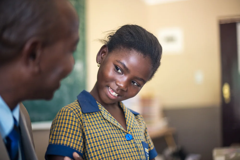 Student in uniform looks at teacher close up.jpg