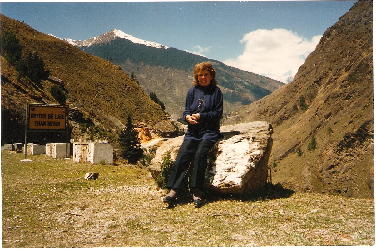 Mom in The Himalayas... the sign reads: "Better be Late, than Never".