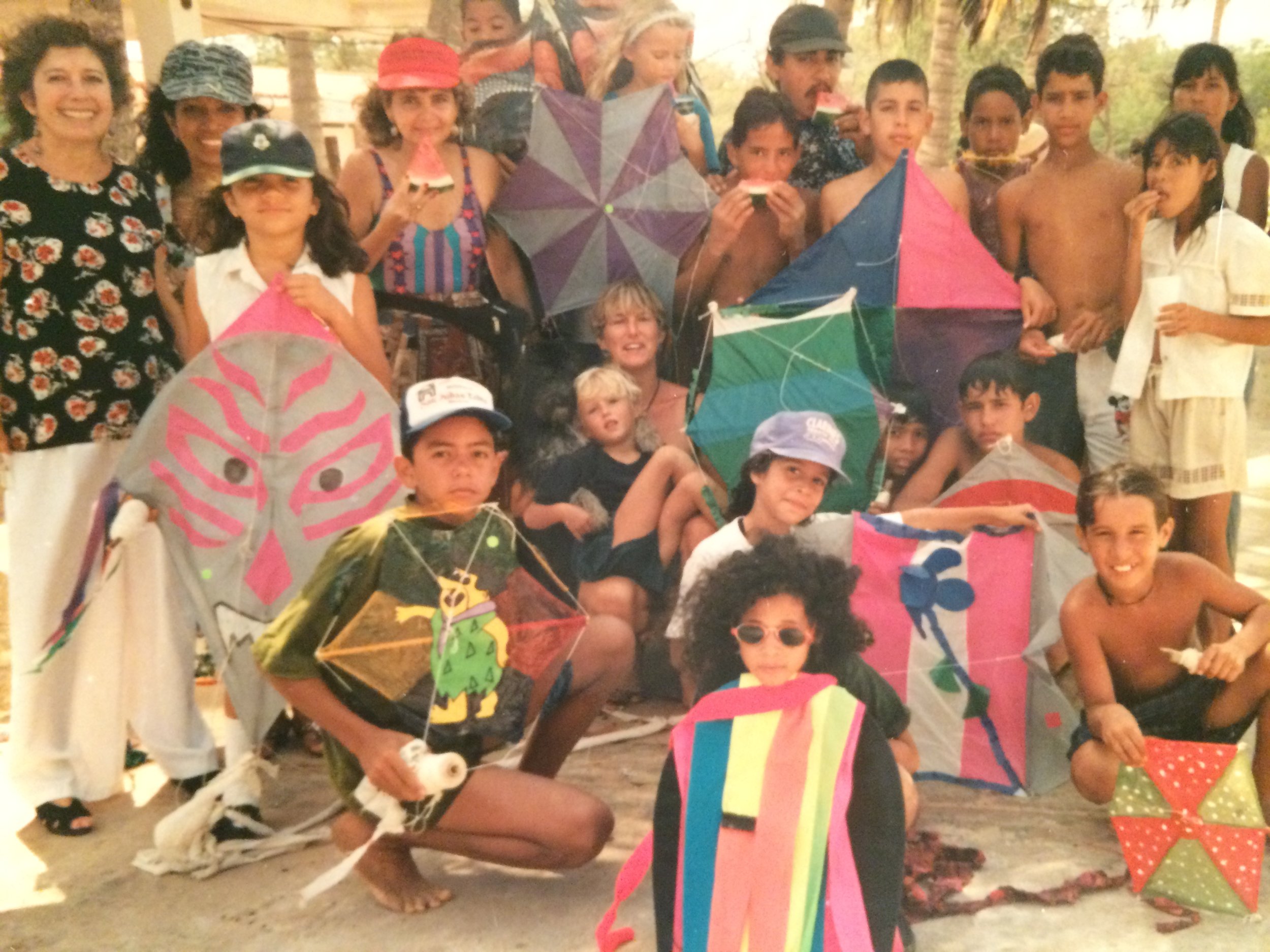 The year my mom organized a kite festival. At the peak of the day we counted 80 kites in the sky at one time. All organized by my mama, who is at the far left in the shirt with flowers.