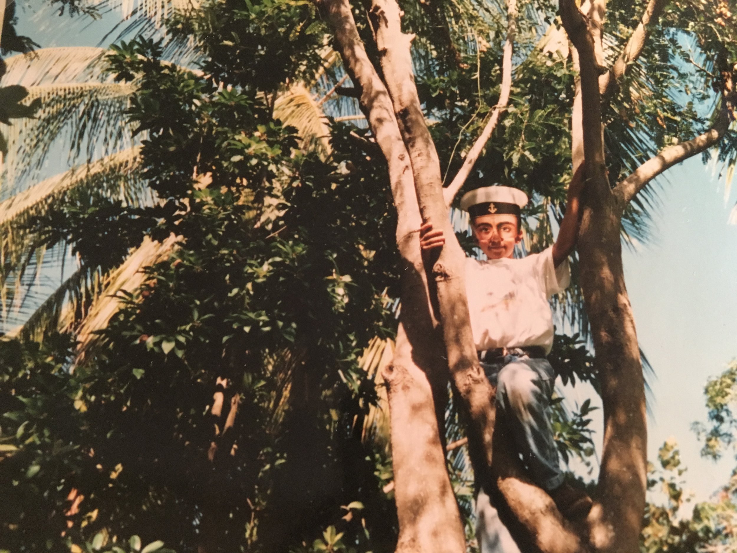 My tree climbing friend and the year of the masks (my mother's doing... she bought hundreds so everyone in the neighborhood would have one).