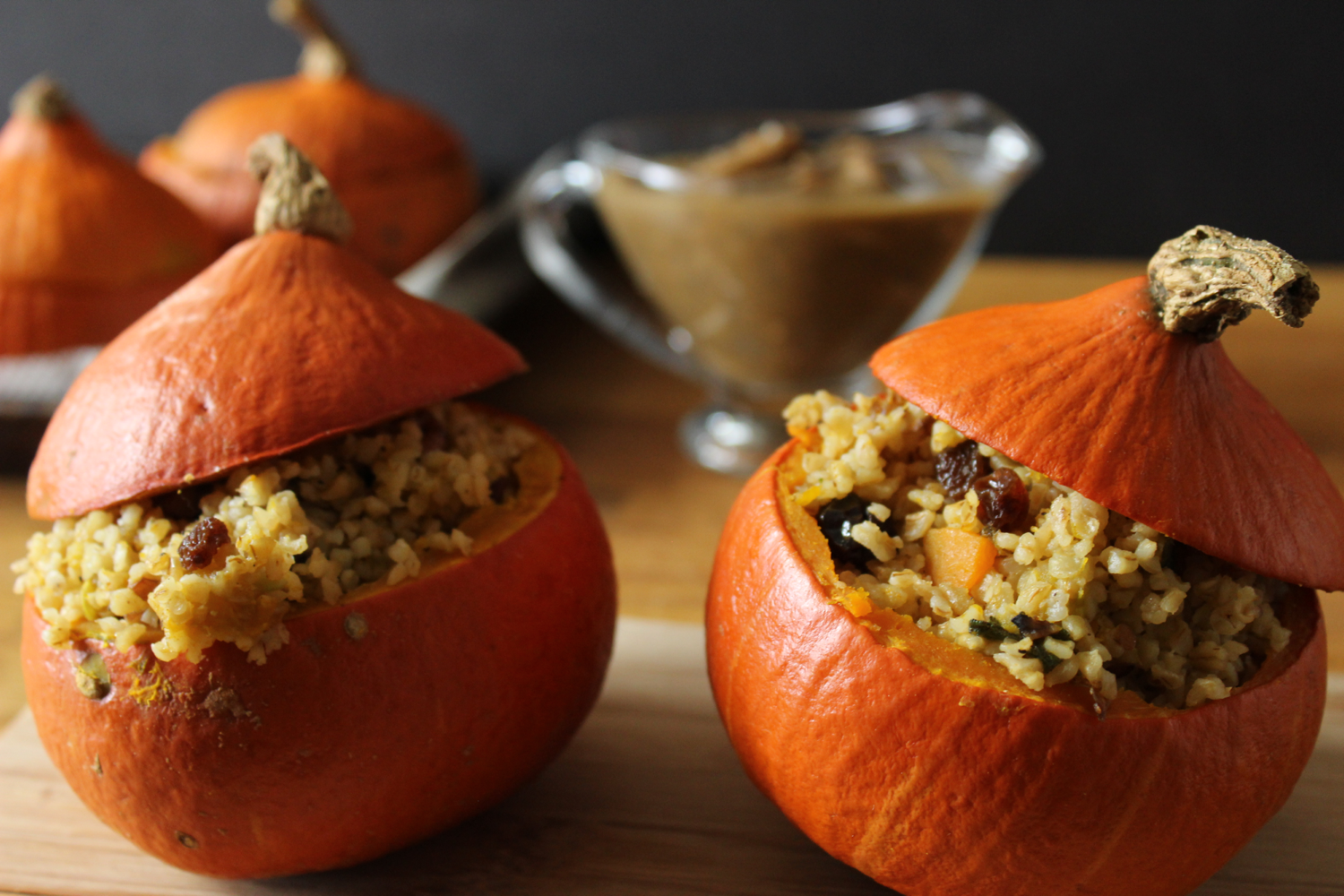 vegan_holiday_recipes_vegan_stuffed-pumpkins_with_a_sage_bulgur_fall_filling_and_a_creamy_mushroom_gravy.png