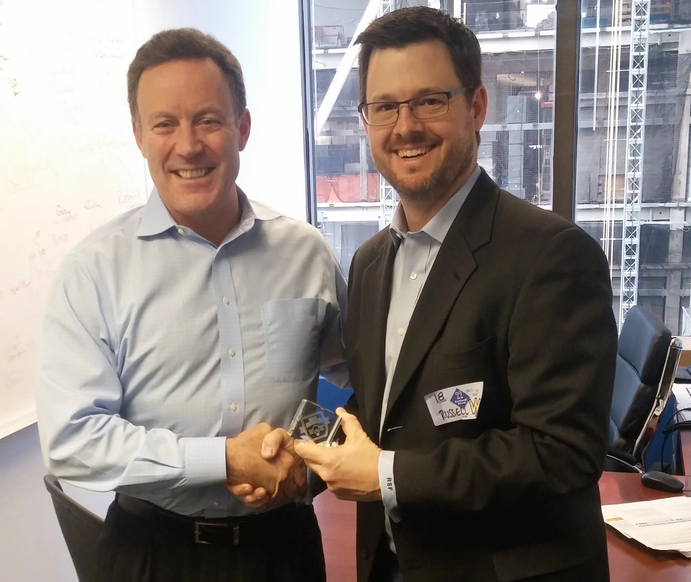 Booker.com's Senior Vice President of Marketing Jim D'Arcangelo (L) accepting the 2016 BIG Innovation Award in New York.from Business Intelligence Group's Managing Director Russ Fordyce (R).