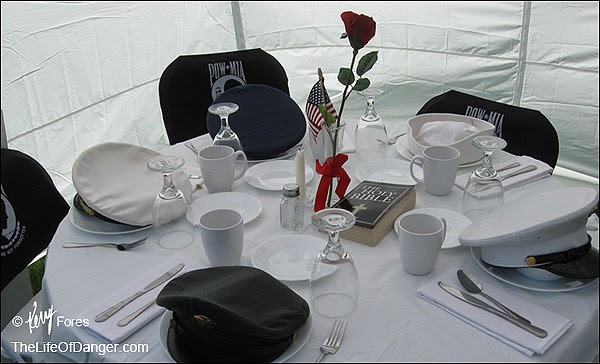 A linen-covered table carefully prepared for guests whom could not attend.