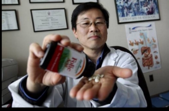 Dr. Young-In J. Kim, Gastroenterology and Hepatology at St. Michael's Hospital and also a professor at The University of Toronto, poses for a photo with Folic Acid at the hospital in Toronto, Ontario, Canada. Kim led a study that found the daughters of rats who took folic acid supplements before conception, during pregnancy and while breast-feeding have breast cancer rates twice as high as other rats. They also had more tumors and developed them at a faster rate.