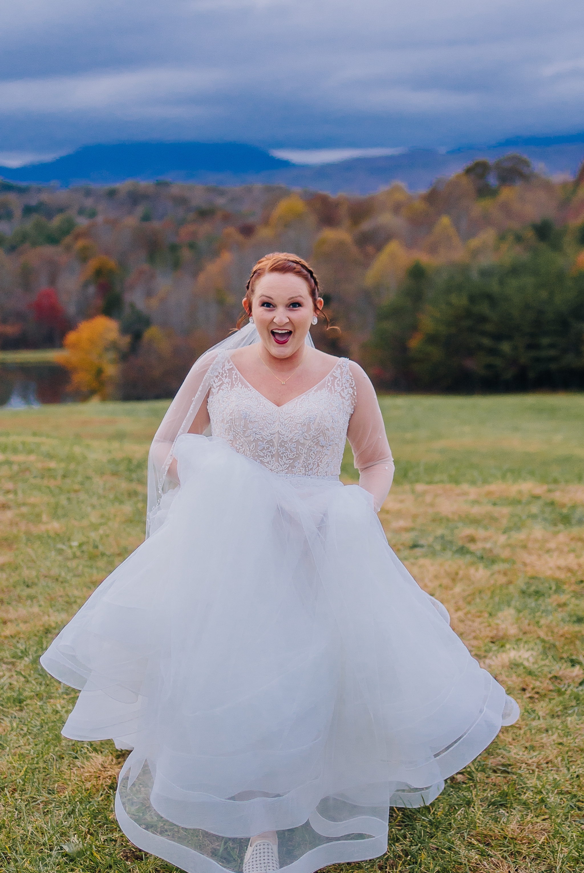  Bride_in_wedding_dress_on_mountaintop_at_glass_hill_venue_Ynchburg_virginia_overlooking_blue_ridge_mountain_by_jonathan_and_hannah_photography