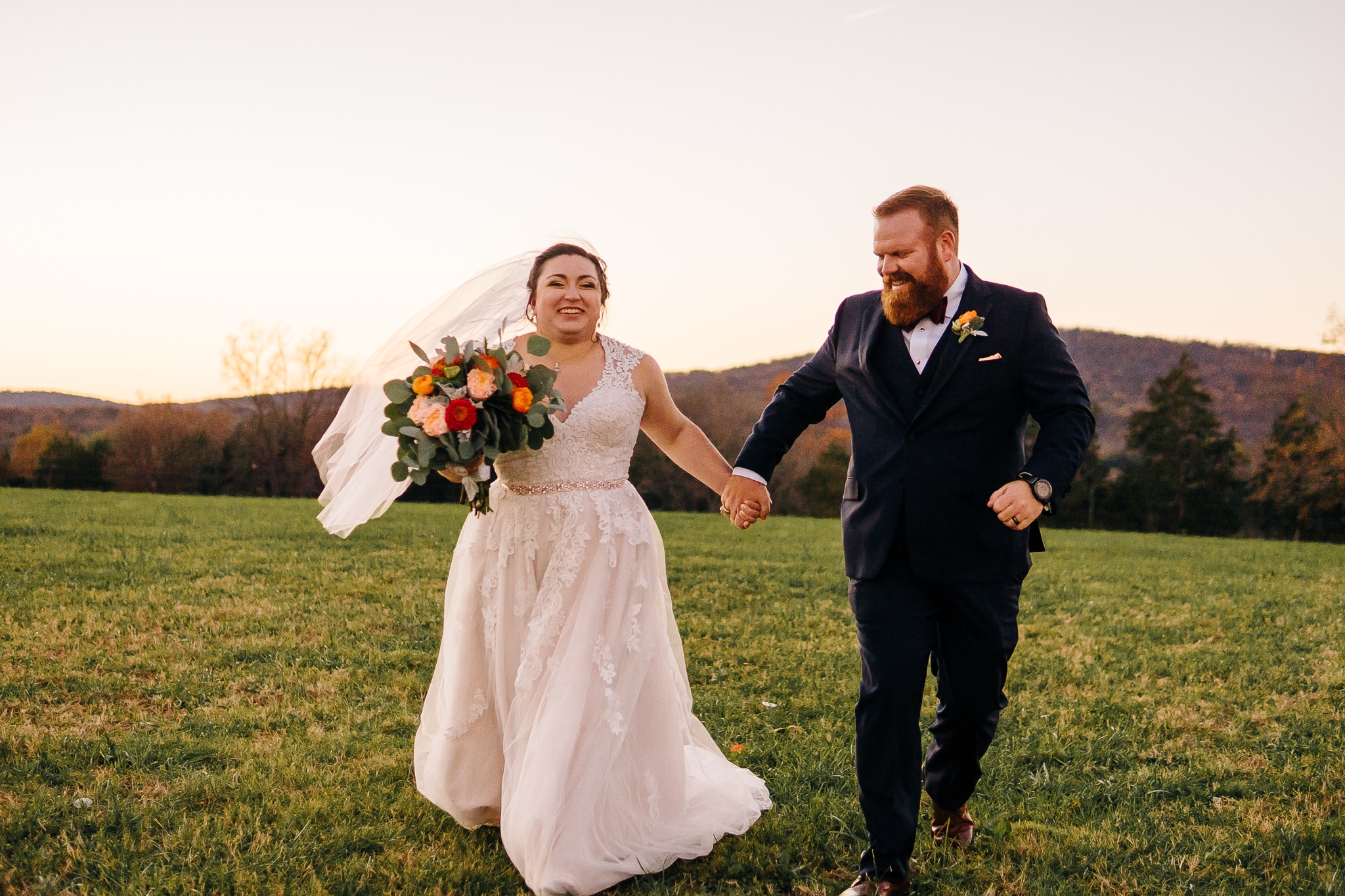 Bride_and_groom_portraits_running_in_field_at_wolftrap_farms_by_jonathan_and_hannah_photography