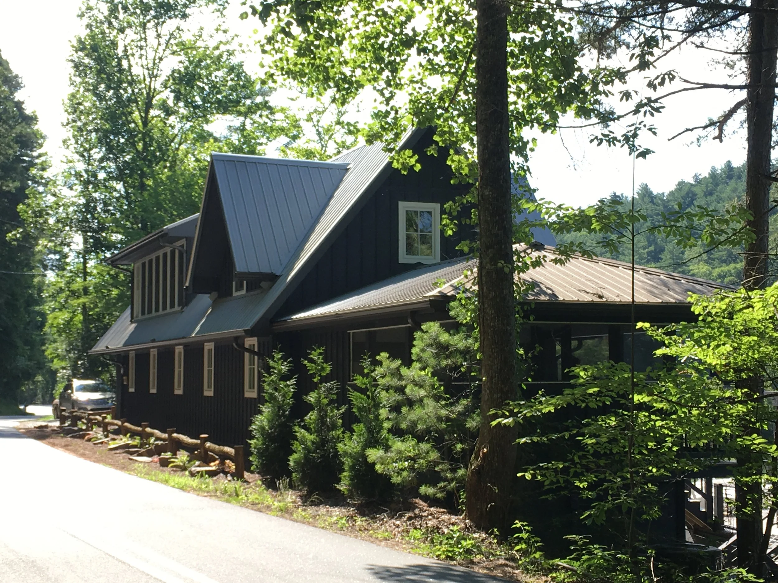 Street side elevation with new screened porch in the foreground