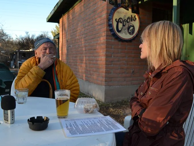 That's Mel chatting with novelist Jim Harrison at the Wagon Wheel Saloon. Yes, she is considering the chicken enchiladas. And yes, that is a half eaten piece of rhubarb pie from Gathering Grounds Cafe, also in Patagonia, Ariz.&nbsp;