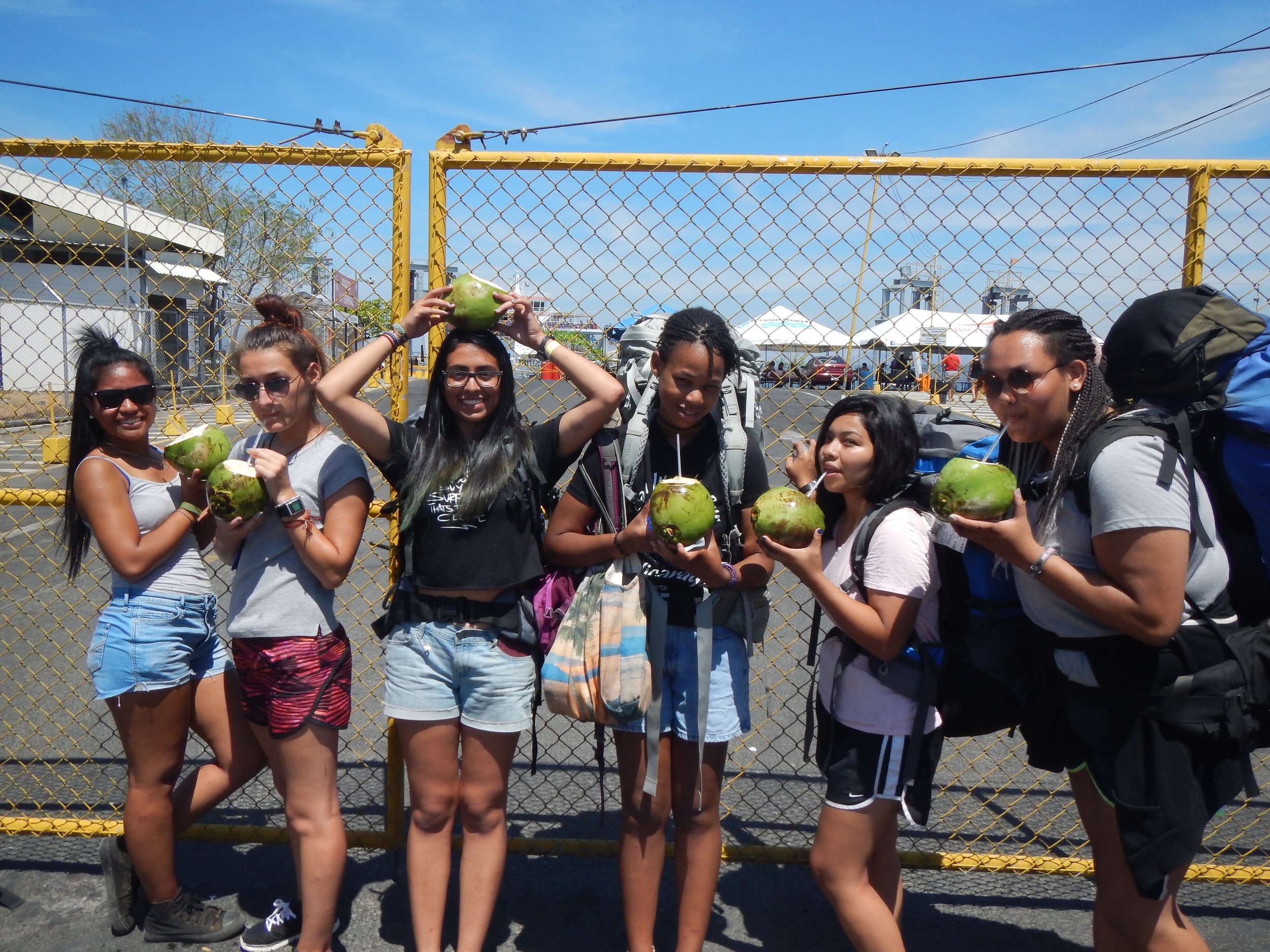 The chicas drinking pipa (cold coconuts) waiting for the ferry
