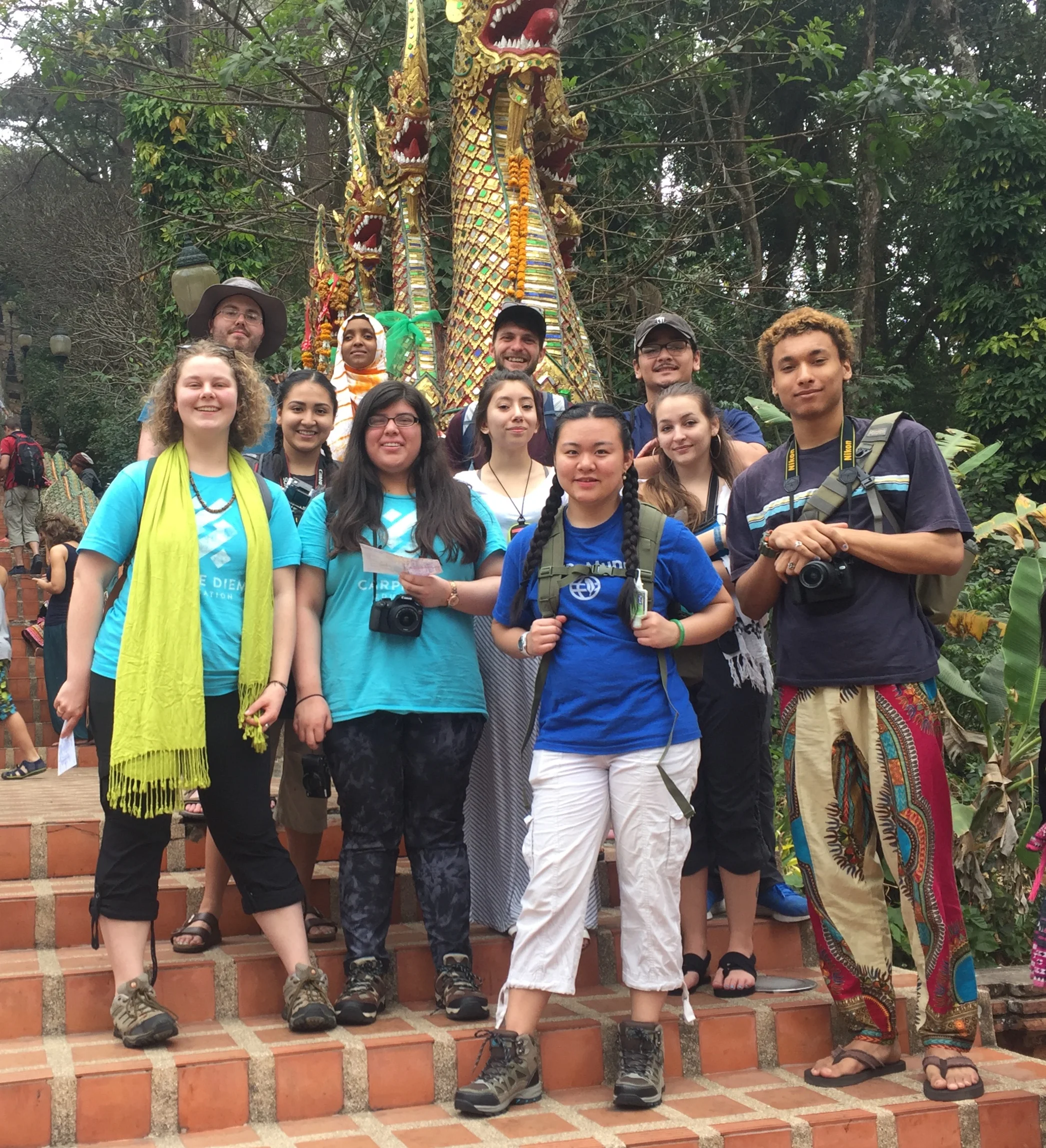 The Hathai group poses under the nagas that guard the entrance to the the mountain-top temple of Wat Doi Suthep 