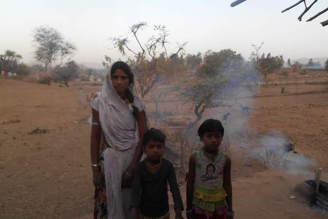 Nakkia-bhai, Shiva, and Pooja at home with the fire fon or chai in the background.