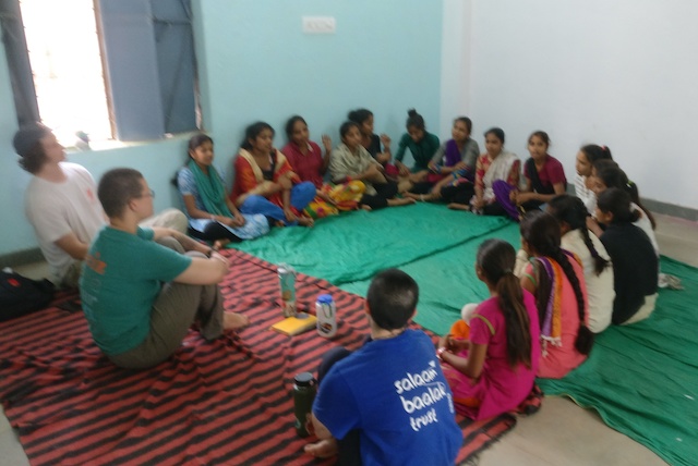 Georgia, Olivia, and Owen facilitate games in a classroom in Jhadol.