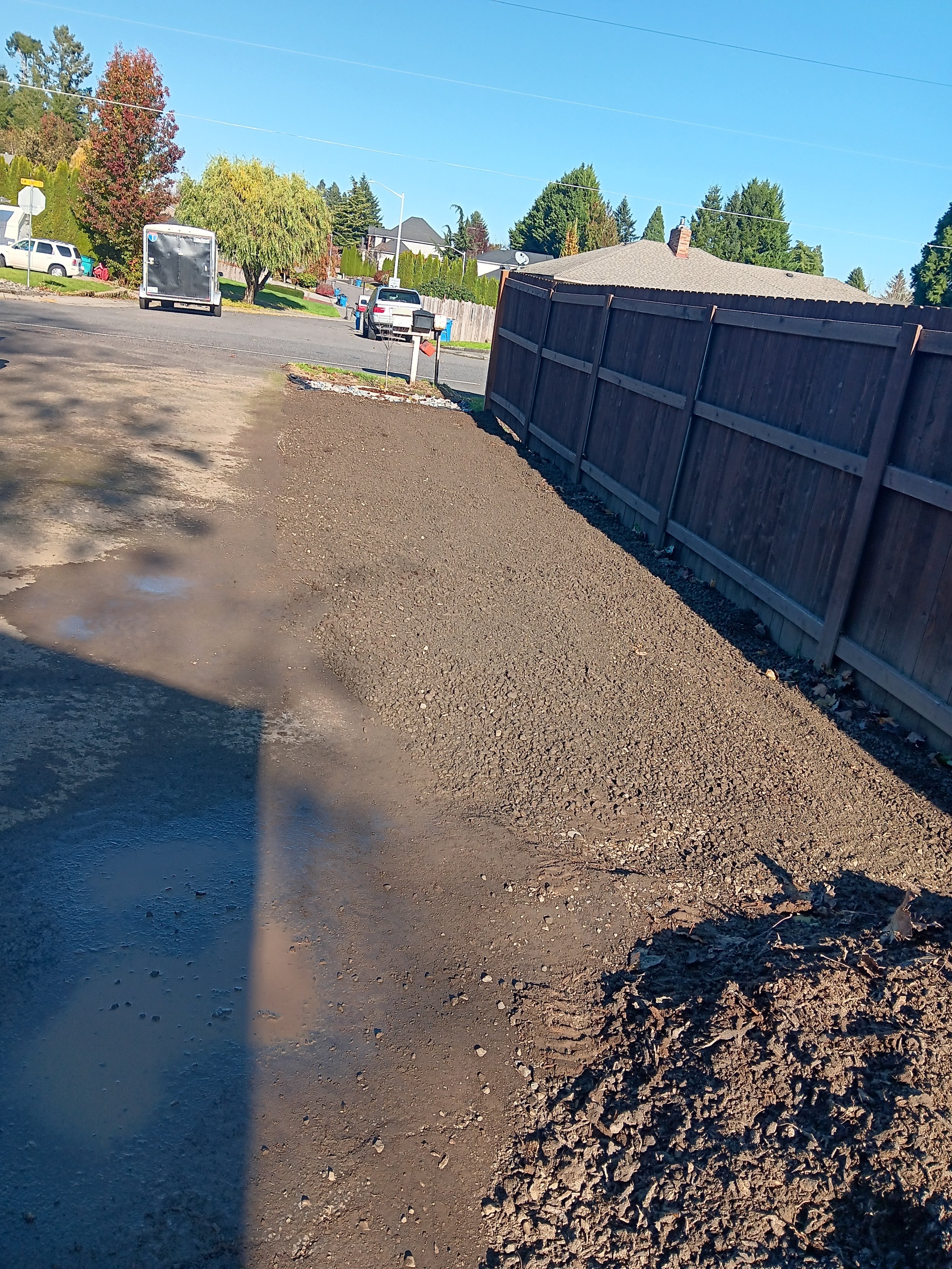 I pushed the stump grinding debris out of the way and then spread and leveled the gravel with my tractor. ,