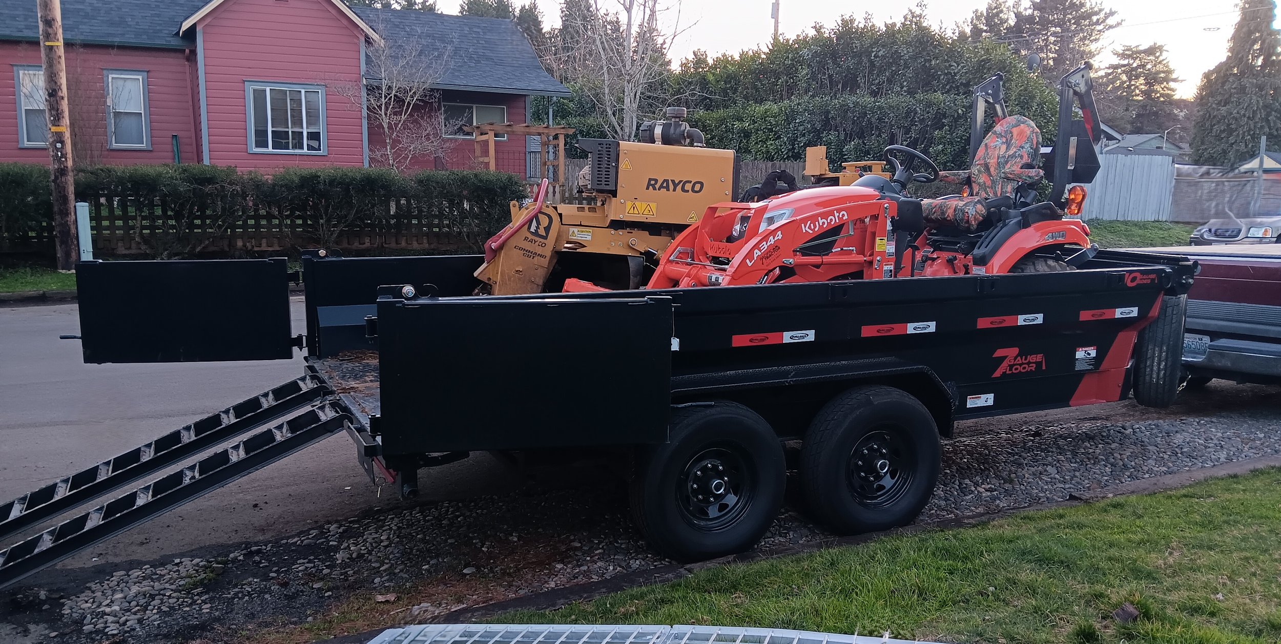 Tractor and grinder loaded into the 14’ dump trailer.
