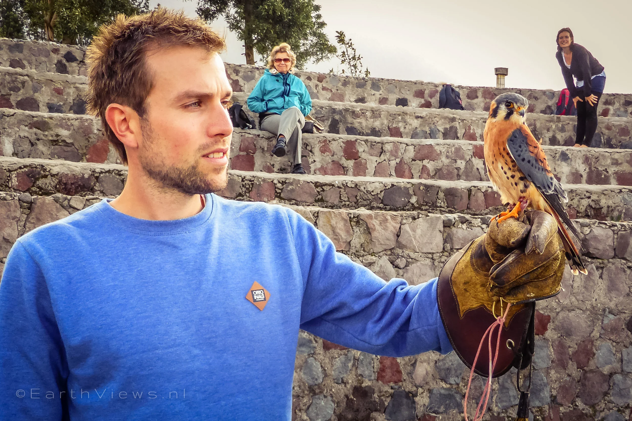 Me holding an American kestrel (a small falcon) at the Condor Park. See how the bird flirts with me?