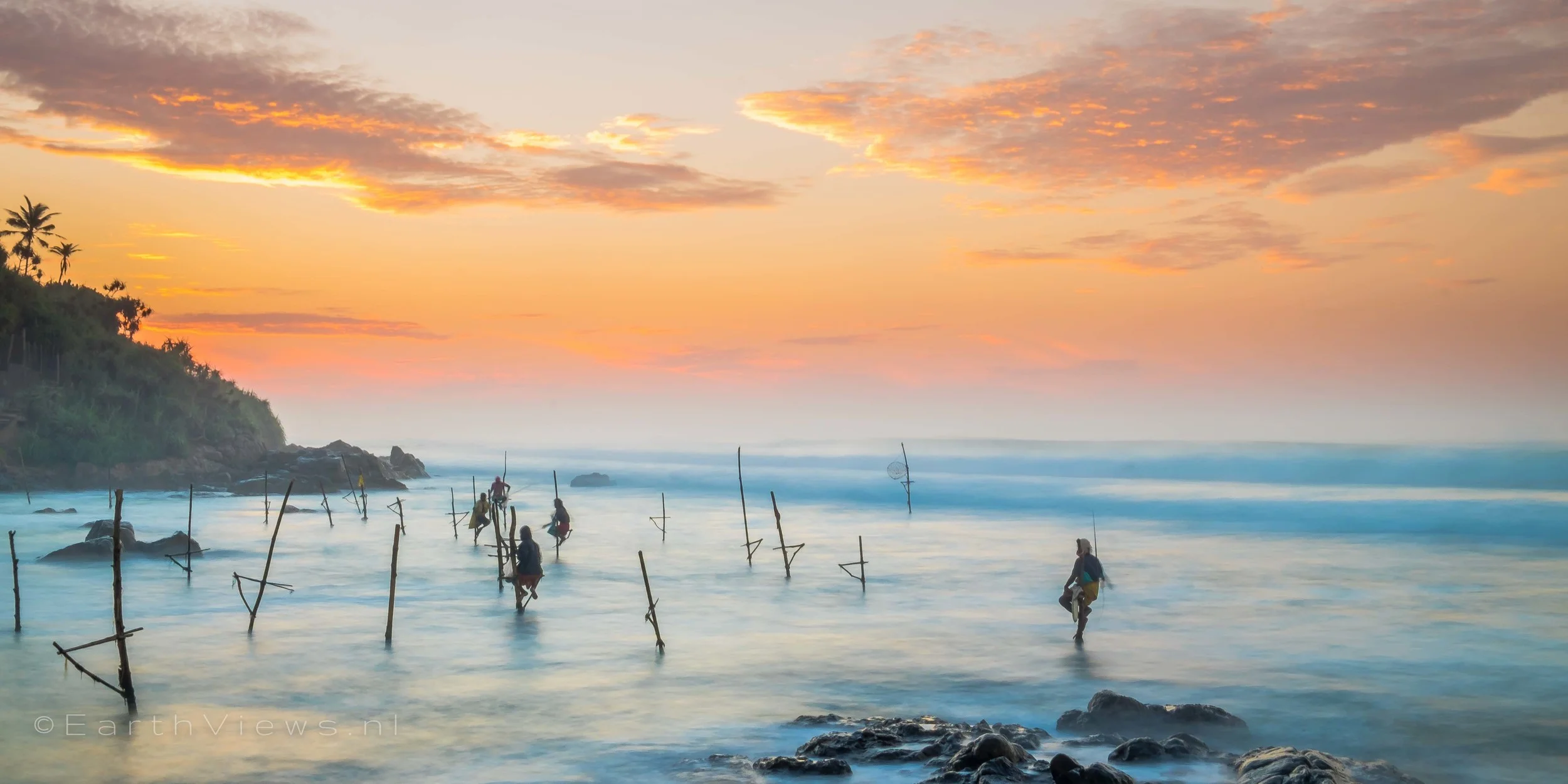 Stilt fishermen at the beach of Weligama, Sri Lanka.