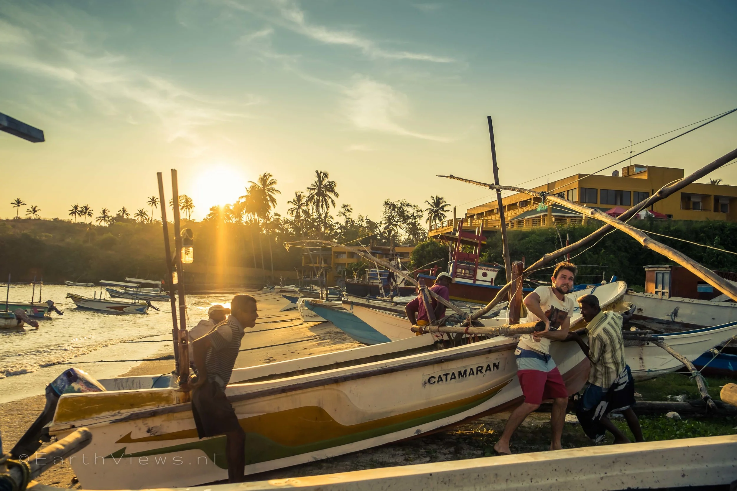 Helping the fishermen push a boat into the water at Weligama harbour.