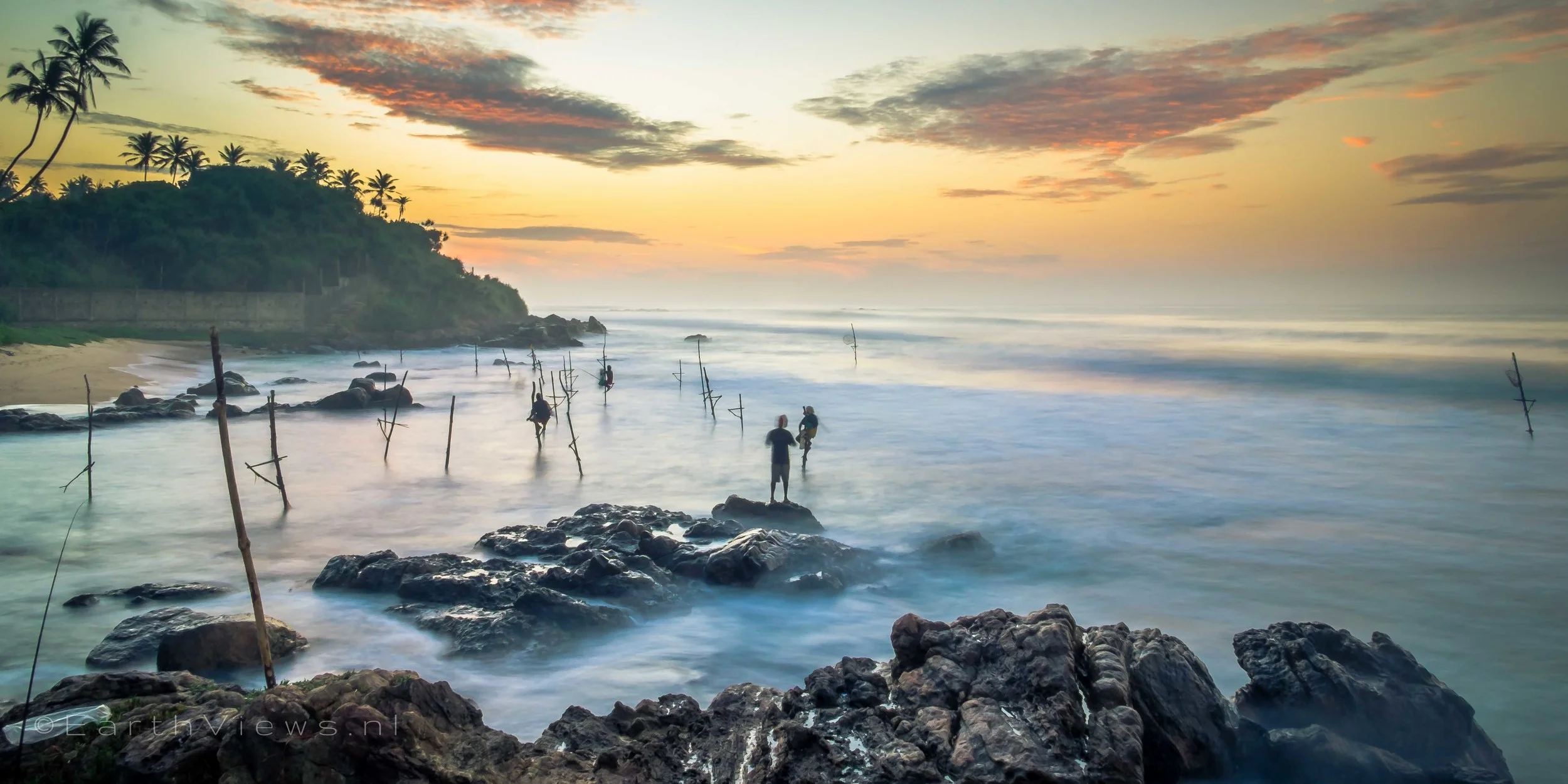 Stilt fishermen at the beach of Weligama, Sri Lanka.